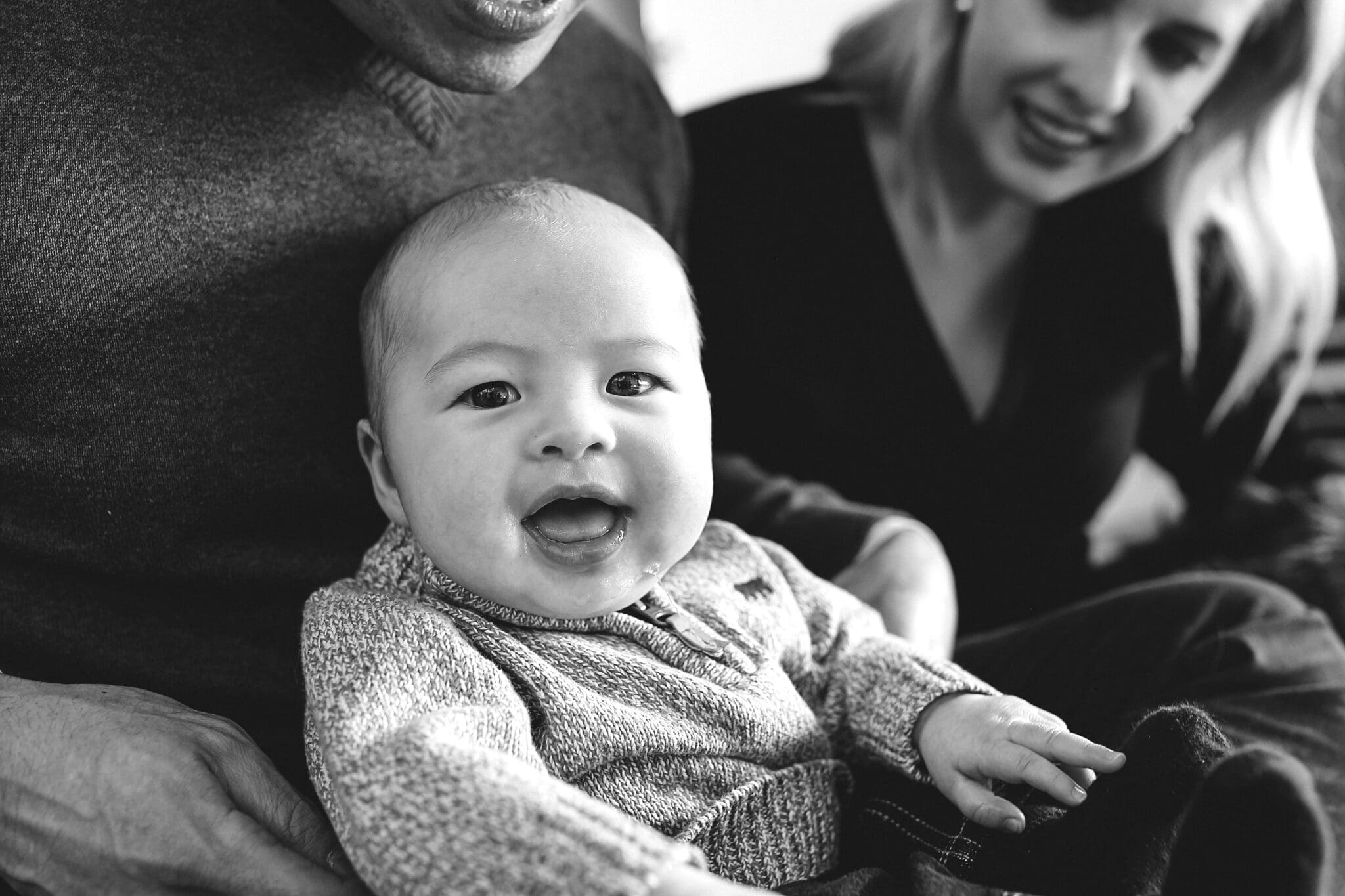 Close up of a baby with a happy expression in an example of lifestyle photography.